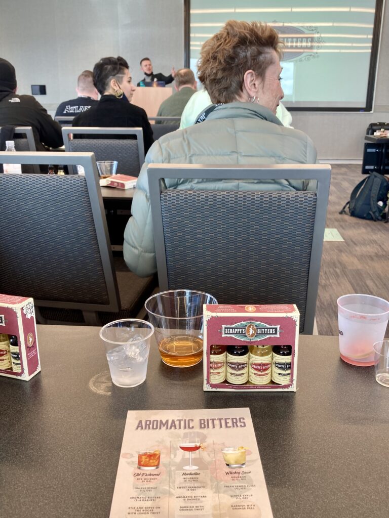 Attendees enjoying a presentation and free sample bitters from Scrappy's Bitters during the Bartender's Circle Summit at Seattle Cocktail Week.